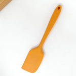 Action Shot: Orange Silicone Spatula in Use – Perfect for Mixing Batter, Scraping Bowls & Frosting Cakes