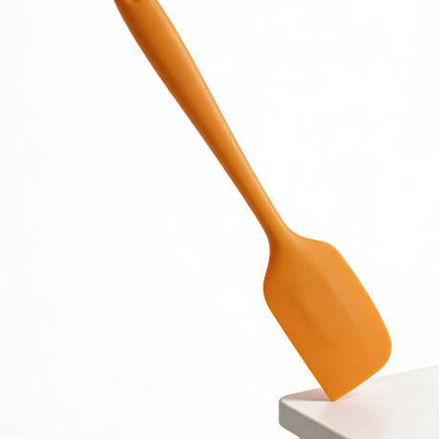 Action Shot: Orange Silicone Spatula in Use – Perfect for Mixing Batter, Scraping Bowls & Frosting Cakes