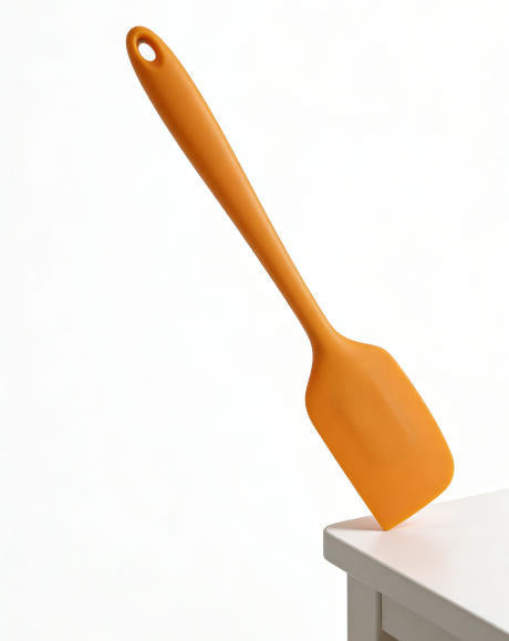 Action Shot: Orange Silicone Spatula in Use – Perfect for Mixing Batter, Scraping Bowls & Frosting Cakes